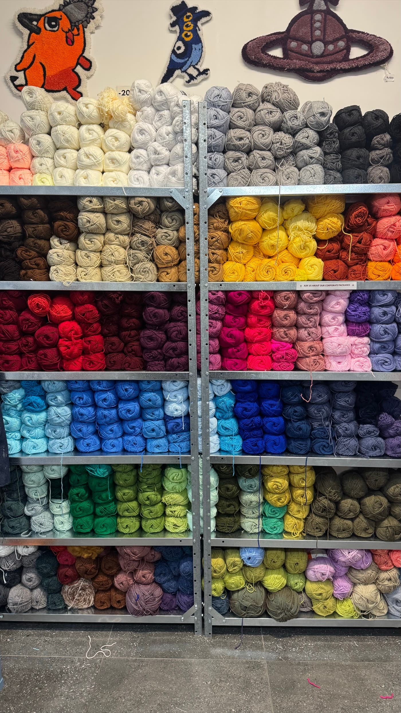 Colourful yarn shelving in a wooden frame at Fybre Studios