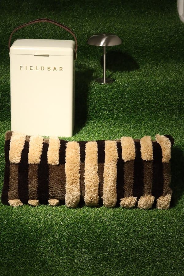 Striped scatter cushion staged beside a Fieldbar cooler