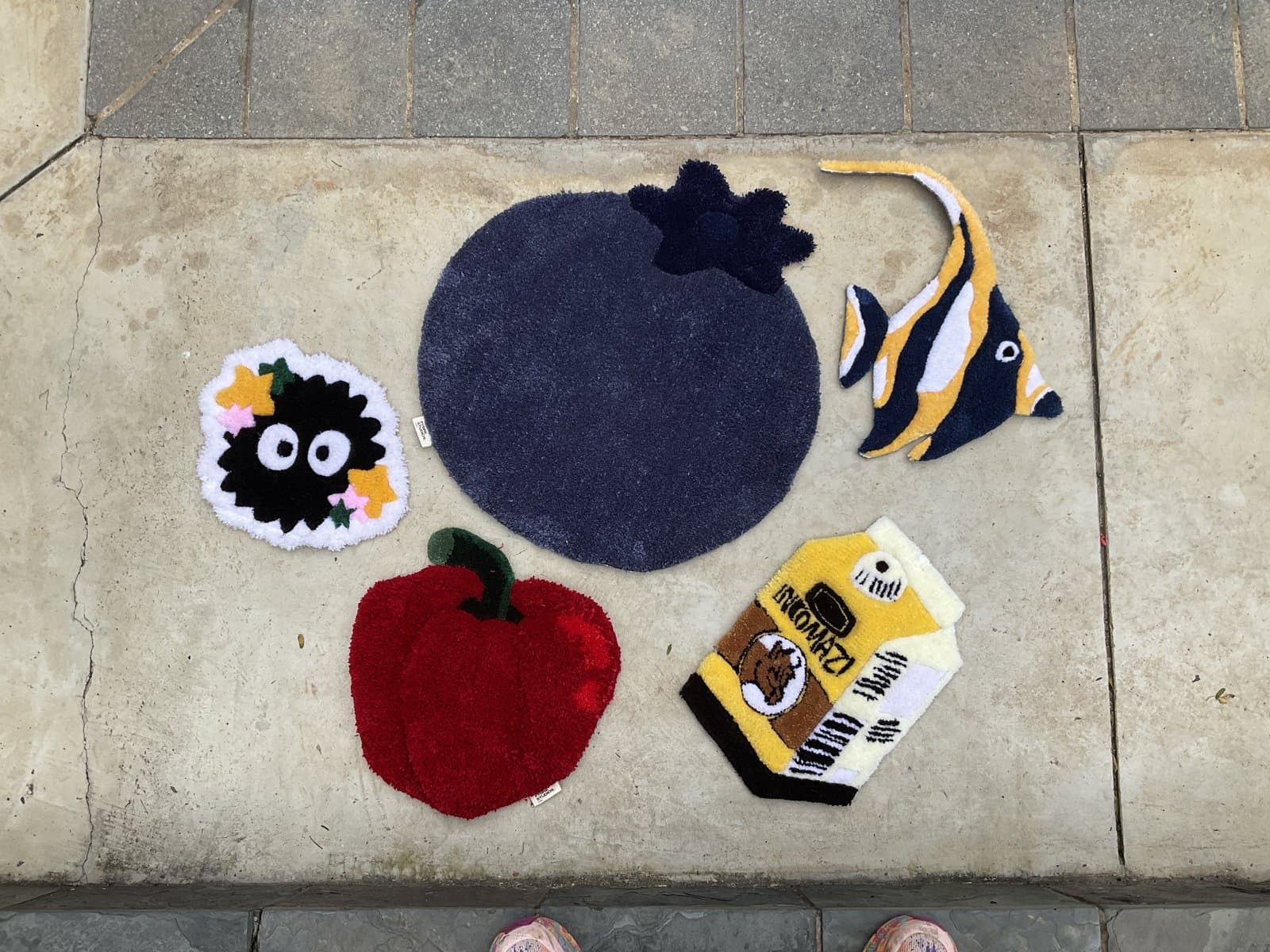 Assorted small tufted patches laid out on the floor