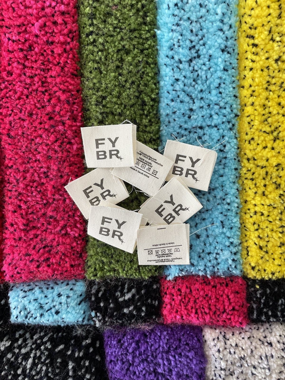 FYBR branded tags on colourful yarn swatches