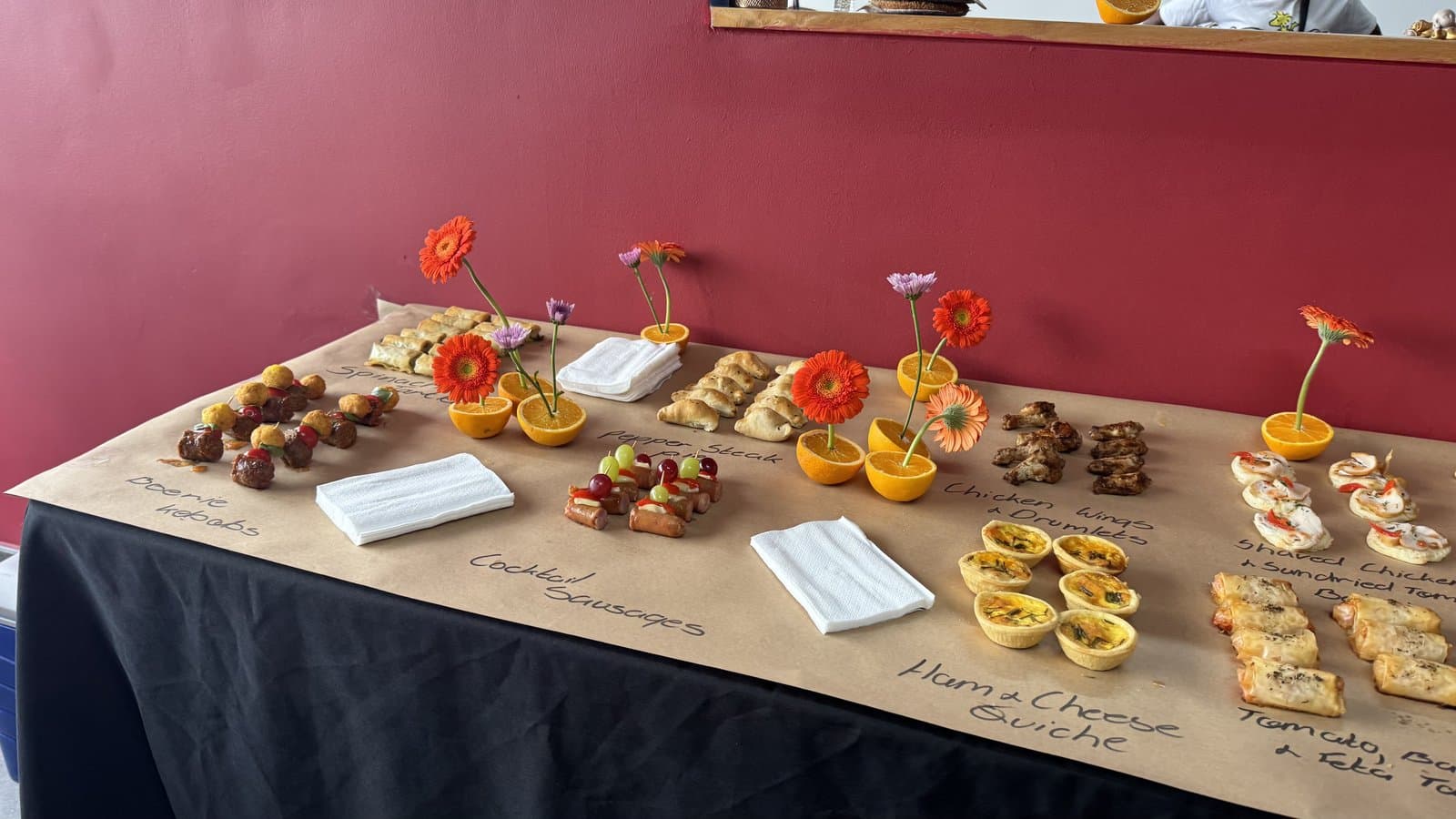 Table spread of snacks and tufted pieces at a studio event