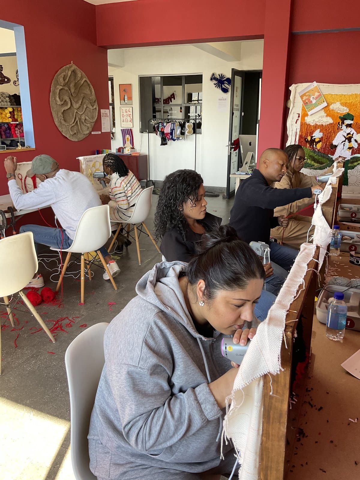 Student focused on tufting at the frame