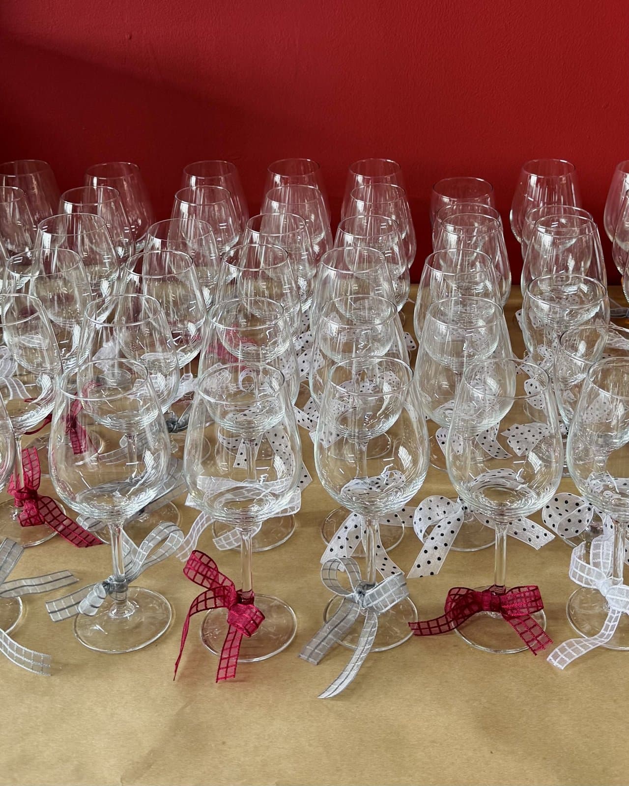 Wine glasses set up with ribbon favours for a studio event