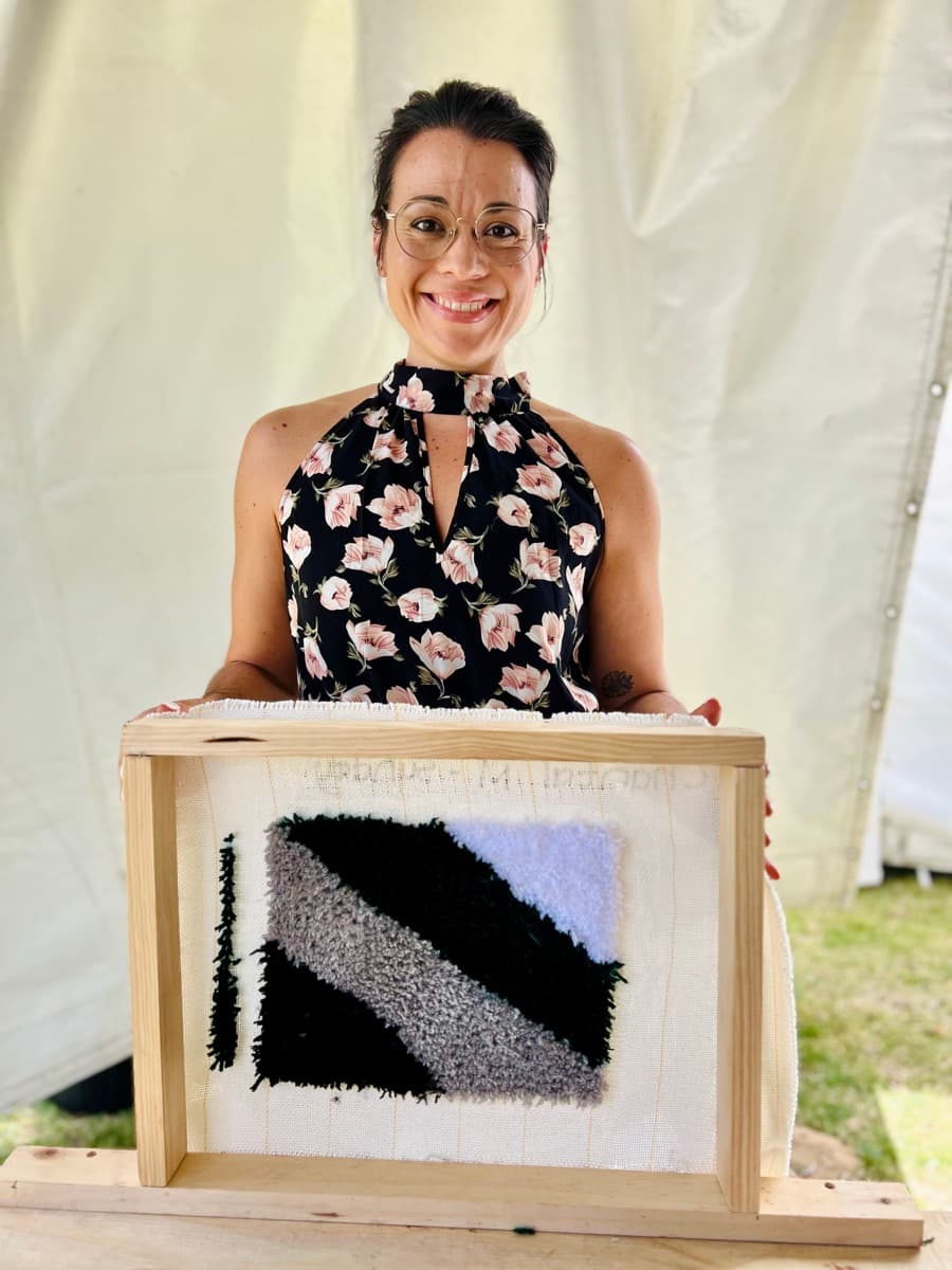 Guest tufting a rug at a Fybre Studios class or market event