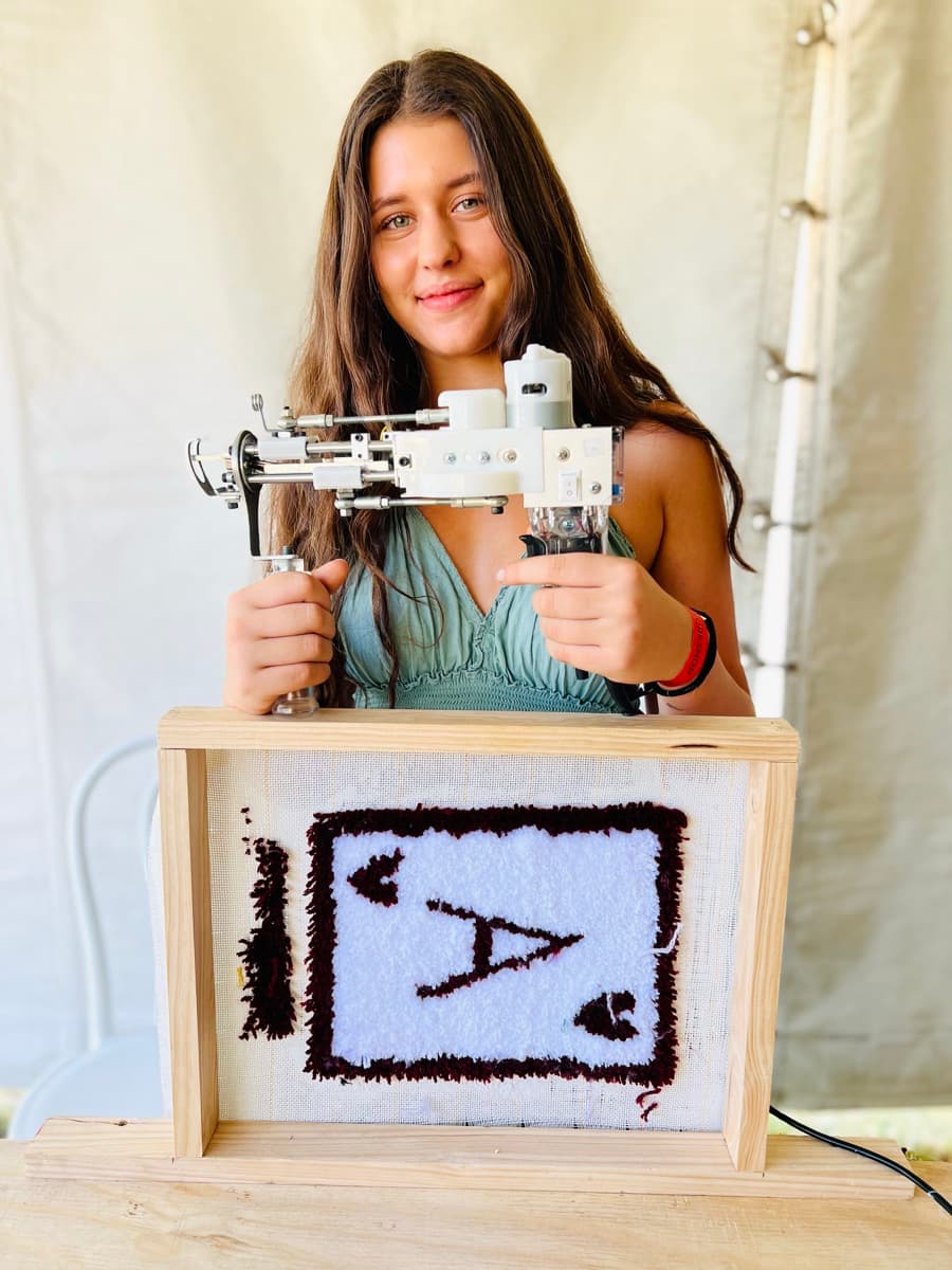 Guest tufting a rug at a Fybre Studios class or market event