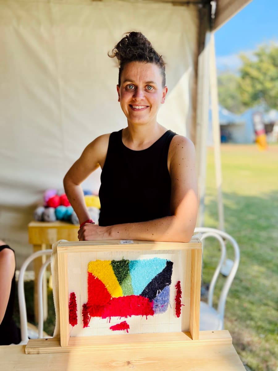 Guest tufting a rug at a Fybre Studios class or market event