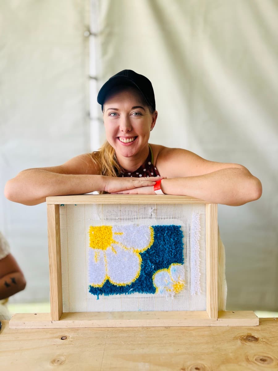 Guest tufting a rug at a Fybre Studios class or market event