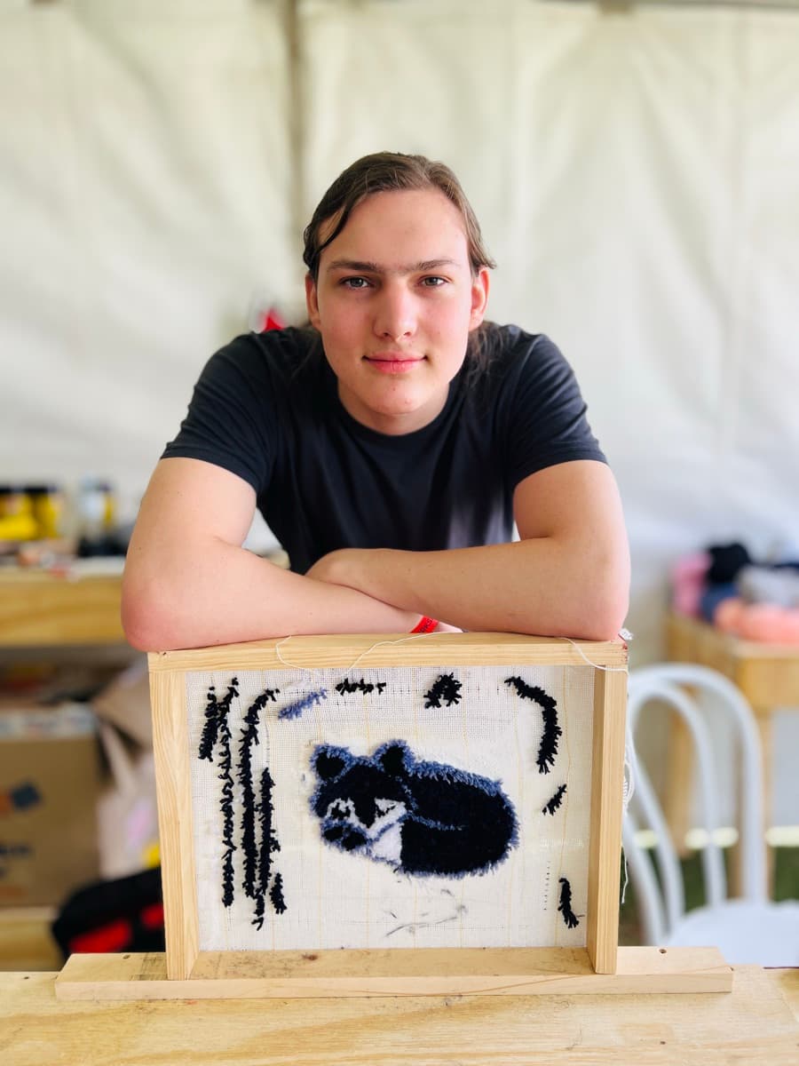 Guest tufting a rug at a Fybre Studios class or market event