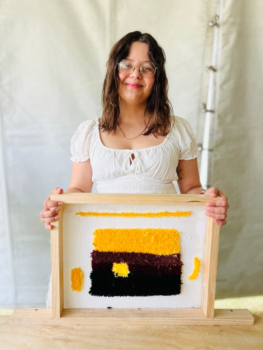 Guest tufting a rug at a Fybre Studios class or market event