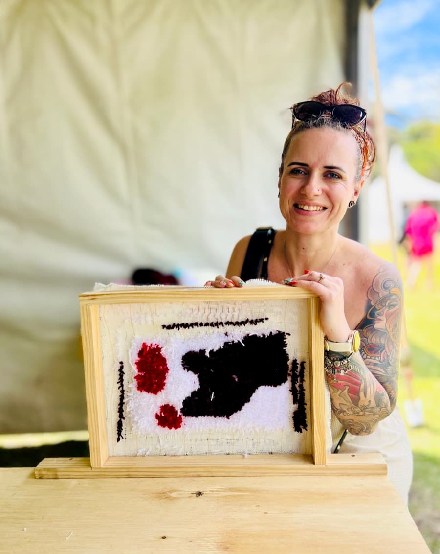 Guest tufting a rug at a Fybre Studios class or market event