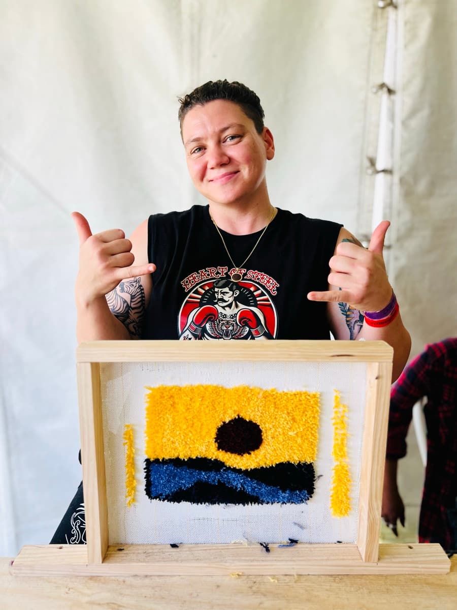 Guest tufting a rug at a Fybre Studios class or market event