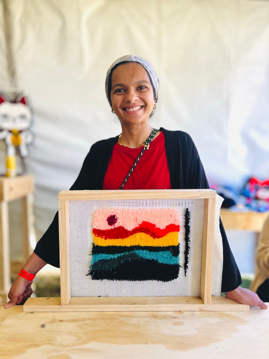 Guest tufting a rug at a Fybre Studios class or market event