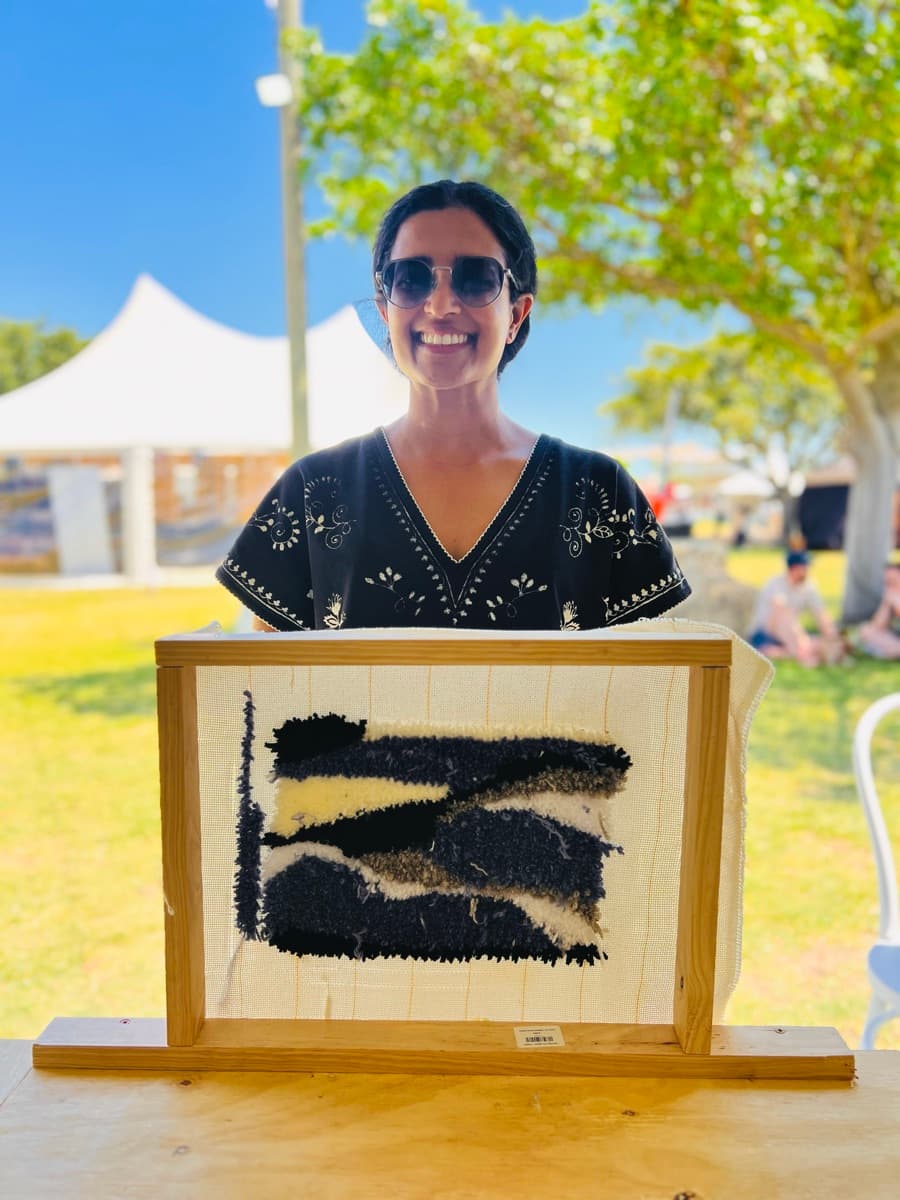 Guest tufting a rug at a Fybre Studios class or market event